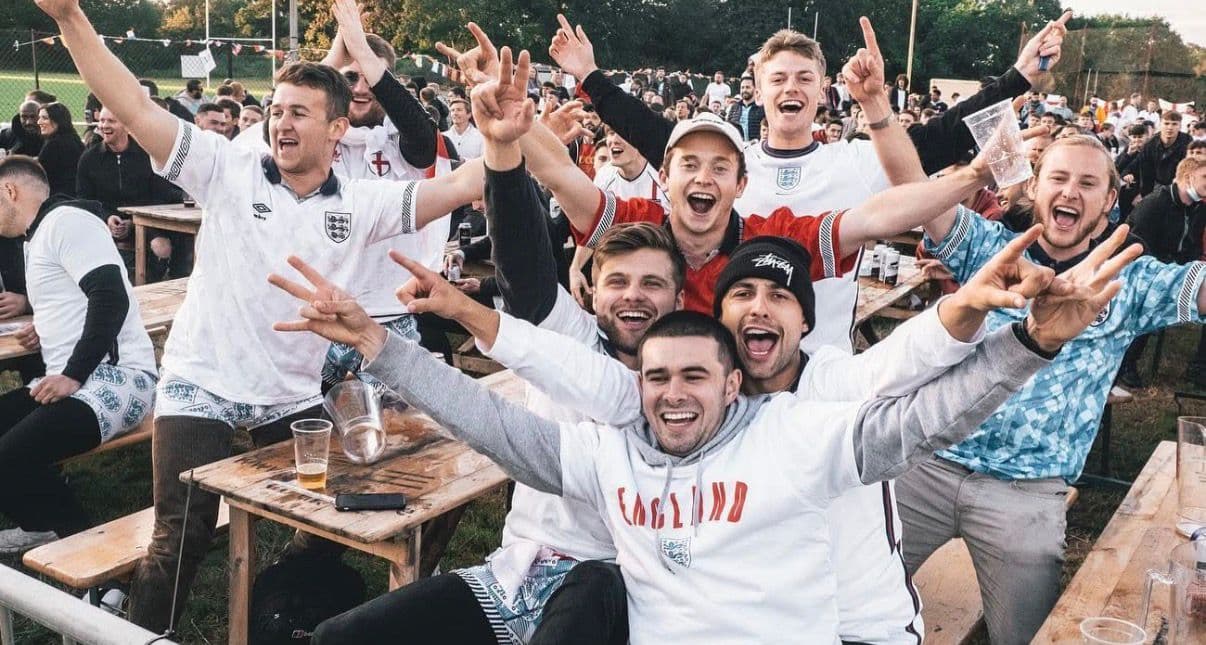 Group of England football fans celebrating a goal at FanZone UK